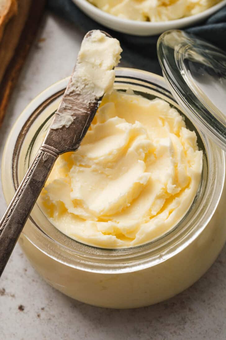 A glass jar filled with homemade butter.