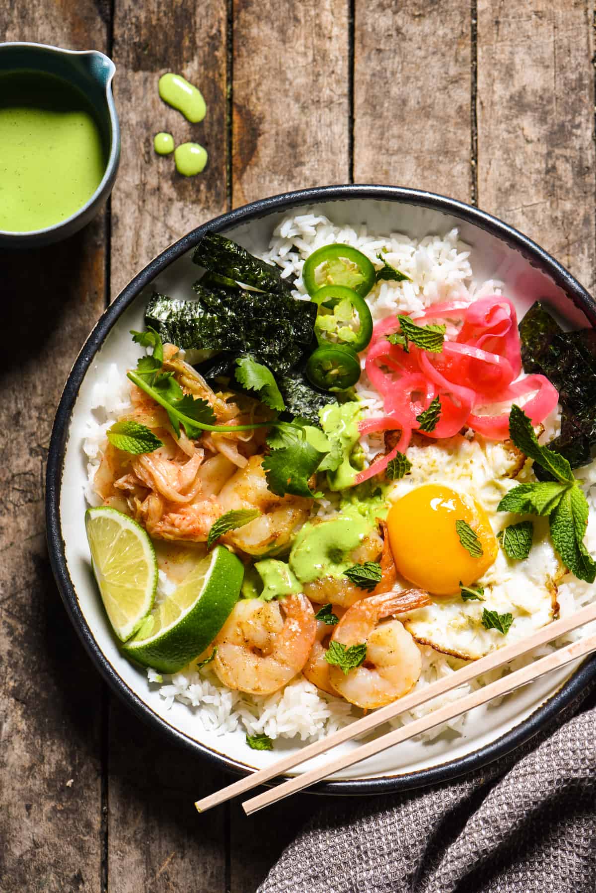 Funky Good Rice & Shrimp Bowls - Shake up your weeknight dinner routine with a rice bowl loaded with shrimp, pickled veggies and a fried egg, and topped with an easy homemade green chili sauce. | foxeslovelemons.com