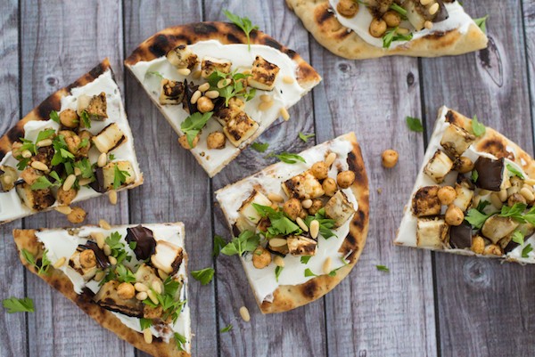 Grilled Eggplant Flatbread - A lovely vegetarian meal or party bite that comes together in a flash. Grilled naan bread is spread with creamy Greek yogurt and topped with grilled eggplant, spiced chickpeas and pine nuts. | foxeslovelemons.com