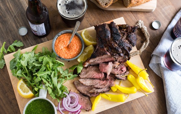 Grilled Lamb Sandwich Platter - Change up your grilling game with a boneless leg of lamb! It cooks in the same amount of time as a thick steak, and has a rich delicious flavor. Pile sandwich fixings, zesty feta spread, chimichurri and rye bread onto a big board, and dinner is served! | foxeslovelemons.com