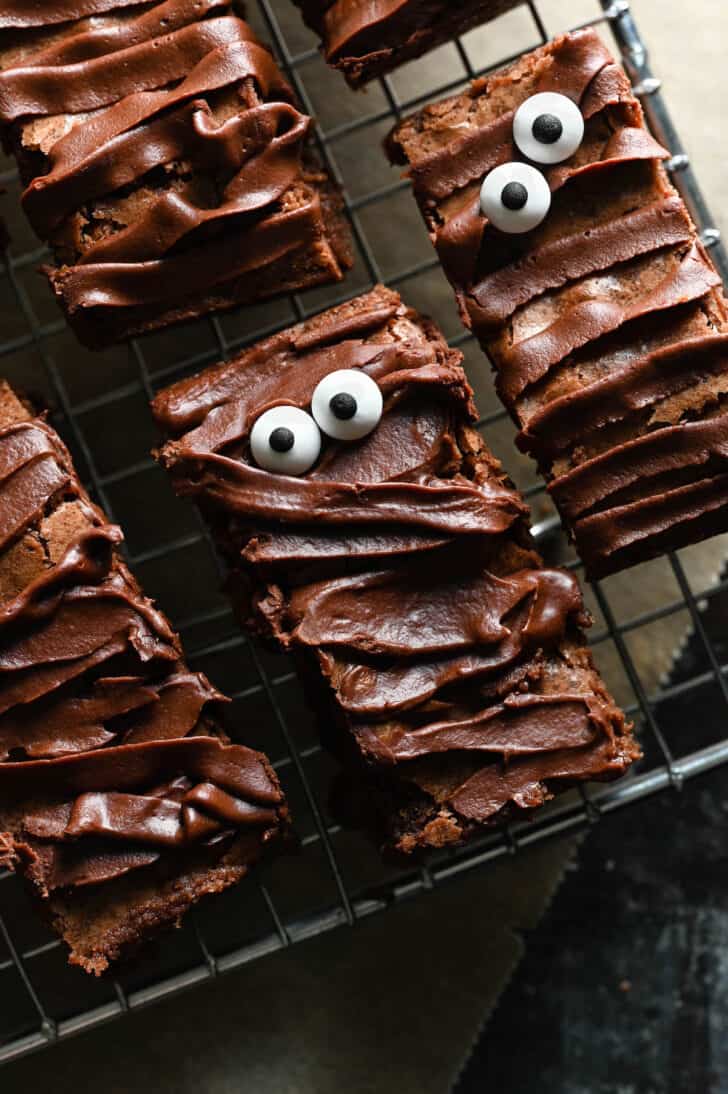 Chocolate treats with ganache frosting and candy eyeballs that look like mummies.