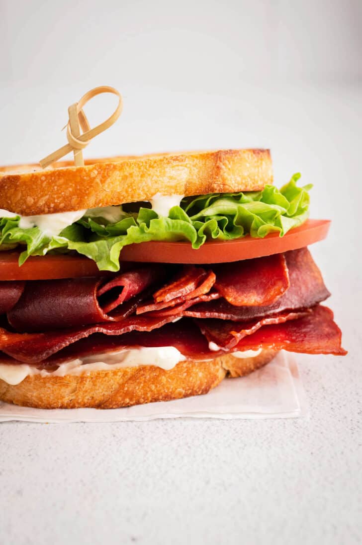 A BLT sandwich made with crusty bread, oven bacon turkey bacon, lettuce, tomato and mayo.