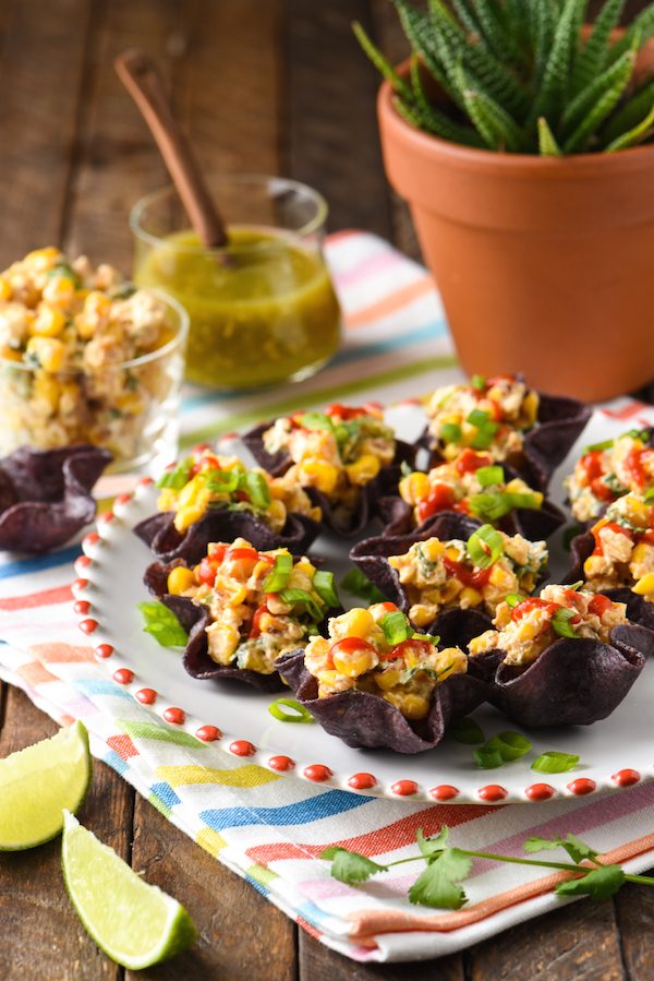 Salsa Verde Elote Bites - Creamy Mexican street food-style corn served in mini tortilla bowls. A perfect EASY party bite! | foxeslovelemons.com